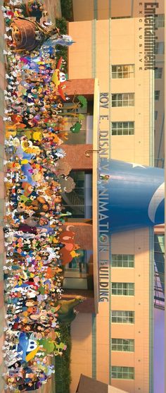 a large crowd of people standing in front of a tall building with a giant blue tube