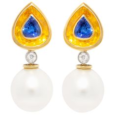 The sapphire earrings feature two faceted pear shape blue sapphires encrusted into two larger faceted yellow sapphires, a rare technical feat. (Total weight of sapphires is 15.51 carats). The tops suspend –via a round diamond- a pair of lovely 14mm South Sea pearls. All of our pearls are untreated: their natural color and luster have not been enhanced in any way. The earrings are one-of-a-kind. They were handmade in Italy in our own workshop in 18 carat yellow and white gold according to an orig Vintage Drop Earrings, Pearl Jewels, Pearl And Diamond Earrings, Sea Pearls, South Sea Pearls, Diamond Drops, Sapphire Earrings, Pearl Diamond, Yellow Sapphire