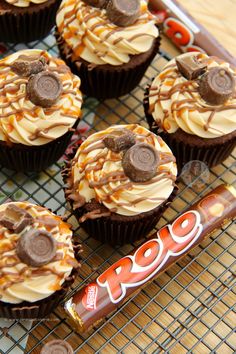 chocolate cupcakes with peanut butter frosting and oreo candy on a cooling rack