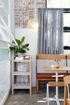 a living room filled with furniture next to a window