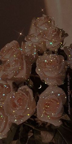 a bouquet of white roses sitting on top of a table