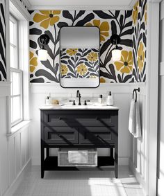 a bathroom with yellow and black wallpaper on the walls, two sinks and a mirror