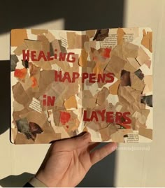 a hand holding up a piece of paper with words on it that say,'healing happens in layers '