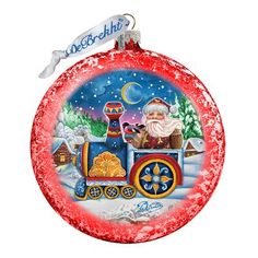 a christmas ornament with a santa clause on the train and snow covered ground