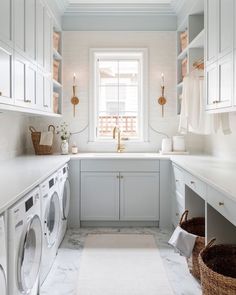 a washer and dryer in a white laundry room