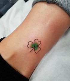 a small four leaf clover tattoo on the ankle