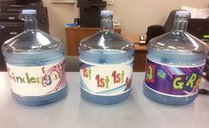 three water bottles sitting on top of a table