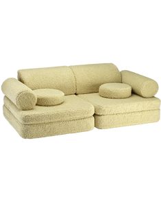 a beige couch with two pillows on it