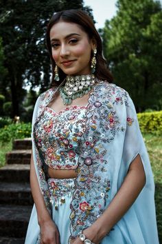 Blue attached cancan lehenga with floral thread and zardosi embroidery. Paired with a zardosi embroidered padded blouse and embroidered cape with scallop edges. - Aza Fashions Light Blue Pre-draped Saree For Wedding, Light Blue Party Sets With Intricate Embroidery, Blue Anarkali Set With Floral Embroidery For Wedding, Blue Floral Embroidery Anarkali Set For Wedding, Light Blue Sets With Intricate Embroidery, Blue Floral Embroidered Sharara For Wedding, Blue Floral Embroidery Sharara For Wedding, Blue Floral Embroidered Sets For Reception, Blue Georgette Choli With Floral Embroidery