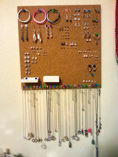 a bulletin board with lots of jewelry hanging on it