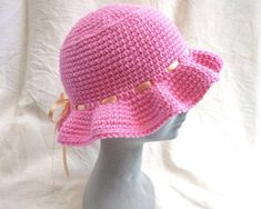 This listing is for one bright pink chunky bucket hat. The hat is handmade using 100% acrylic yarn, and a minimal and cute design with a sweet ribbon bow and a wavy brim. The chunky yarn and big brim give the hat a slightly oversized look, while the hat can be adjusted to smaller sizes using the ribbon which ties at the back. The ribbon can also be easily removed if you find you don't need it to tighten the hat, and would prefer it without. The hat circumference measures approximately 57cm, to f Handmade Pink Yarn Mini Hats, Playful Pink Brimmed Crochet Hat, Handmade Adjustable Pink Bucket Hat, Playful Pink Hand Knitted Hat, Playful Hand-knitted Pink Hat, Playful Pink Hand-knitted Crochet Hat, Pink Adjustable Crochet Hat In Playful Style, Pink Brimmed Hat For Gift, Cute Pink Crochet Hat For Beach