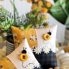 two yellow and black pillows sitting next to each other