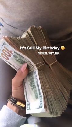 someone is holding money in their hand and it's still my birthday