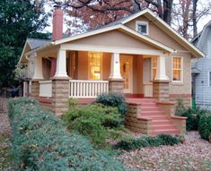 a small house with steps leading up to the front door