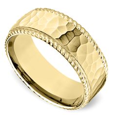 a yellow gold wedding band with braiding inlays on the inside of it