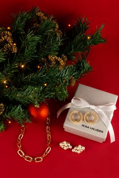 a christmas tree and jewelry on a red background