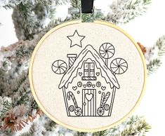 a cross stitch ornament hanging from a christmas tree