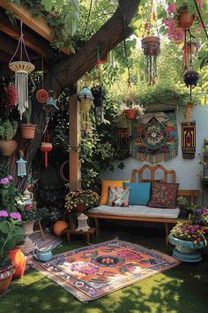 an outdoor area with potted plants and rugs on the ground, hanging from a tree