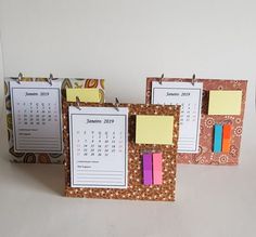 three calendars with sticky notes attached to them