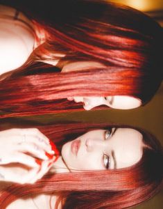 two beautiful young women with long red hair