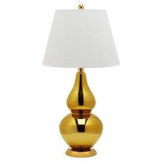 a gold lamp with a white shade on it