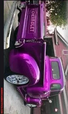 a purple truck parked on the side of a road