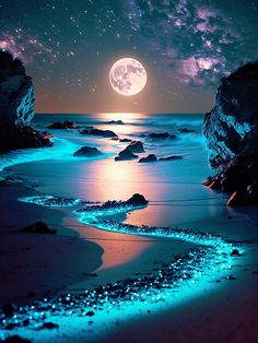 a full moon is seen over the ocean with rocks and water in the foreground