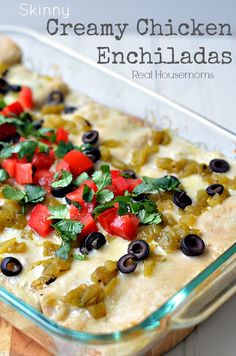 a casserole dish with olives, peppers and chicken