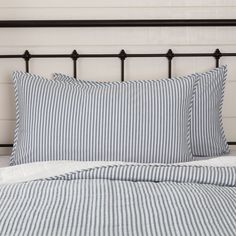 a bed with blue and white striped sheets