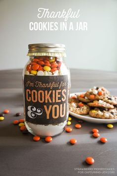 a jar filled with cookies and candy on top of a table