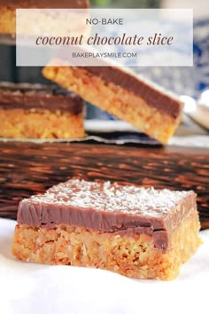 three pieces of chocolate and coconut bar sitting on top of a table