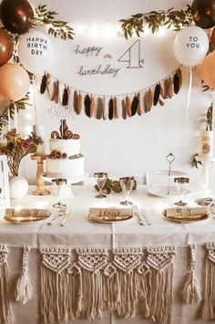 a table topped with lots of cake and balloons