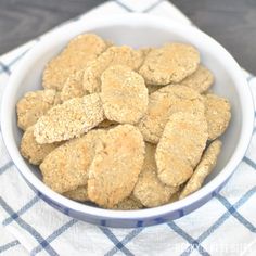 a white bowl filled with cookies on top of a blue and white checkered table cloth