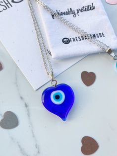 Handmade and one of a kind. Straight from the MediterraneanSea. The gorgeous BEAUTIFUL one of a kind Glass Evil Eye heart amulets will reflect any negative energy with its striking eye. A traditional yet timeless necklace curated for the modern fashionista. Chain Necklaces are 16kt gold plated over brass measuring a 17.5 inch length. This chain is higher quality than my usual charm chains. I had to upgrade it for this unique statement charm. Limited quantities special made for Valentine's Day. T Blue Heart Charm Jewelry As A Gift, Blue Heart Charm Jewelry As Gift, Blue Heart Charm Jewelry For Gift, Blue Jewelry With Heart Charm For Gifting, Blue Heart Charm Jewelry Gift, Blue Heart Pendant Keepsake Jewelry, Blue Necklace With Heart Charm, Blue Necklaces With Heart Charm And Round Shape, Blue Necklace With Round Heart Charm