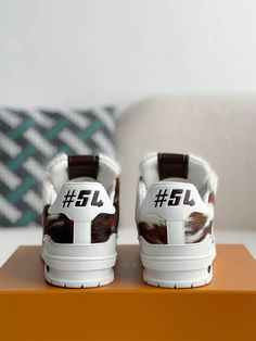 Channel your inner cowboy with these statement-making sneakers inspired by Louis Vuitton's bold and distinctive design. The eye-catching cowhide print, rendered in rich brown tones, sets these shoes apart from the ordinary. Crafted with meticulous attention to detail, they feature the iconic "LV" initials and "#54" signature, paying homage to Louis Vuitton's heritage. Experience the perfect blend of luxury, individuality, and Western flair. Disclaimer: This product is inspired by the Louis Vuitt Designer Brown Custom Sneakers With Round Toe, Brown Luxury High-top Sneakers, Designer Brown Calf Leather Sneakers, Luxury Brown Custom Sneakers For Streetwear, Luxury Brown Sneakers For Streetwear, Designer Custom Brown Calf Leather Sneakers, Designer Brown Calf Leather Custom Sneakers, Pony Sneakers, Fall Winter Jacket