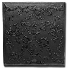 a black plaque with flowers and vines on it