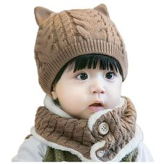 a small child wearing a knitted hat and scarf