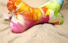 a multicolored pillow on a bed