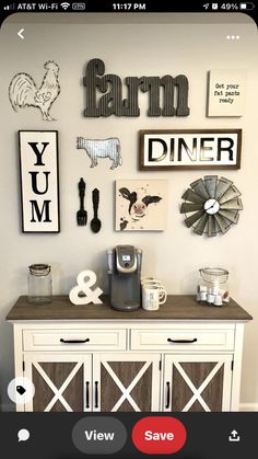 a white cabinet with some pictures on the wall above it and a coffee maker next to it