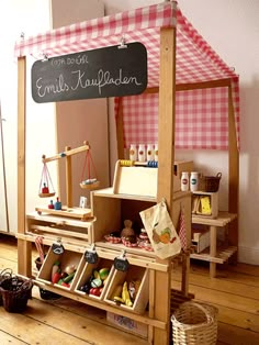 a child's play area with toys and a chalkboard