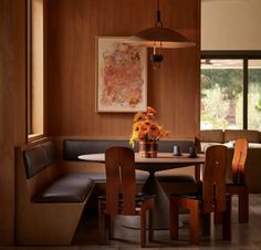 a dining room table with chairs and a bench