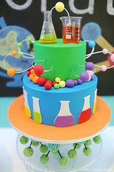 there is a science themed cake on top of the table with test tubes and beakers