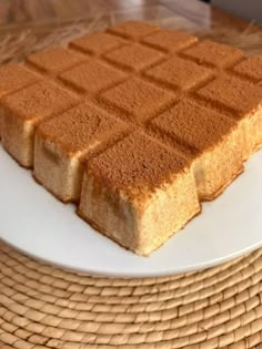 two pieces of cake sitting on top of a white plate next to a wicker basket