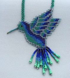 a beaded bird necklace on a white surface