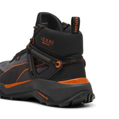 a pair of black and orange hiking boots