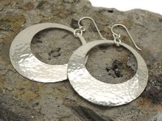 "We made these lightweight large 1 1/2 inch hammered peephole disc earrings by hand. They're made from solid sterling silver. I think that these have a nice weight for their size, as they're about right to wear comfortably. They're a good, large size and catch the light really well. I think that you'll like them. We textured them with a hammer, gave them a dome shape, and then tumble polished them for shine and strength. The large discs are 1-1/2\" in diameter (approx. 38 mm) and the entire earr Silverware Crafts, Hammered Sterling Silver, Disc Earrings, Funky Jewelry, Ethnic Jewelry, Jump Rings, Ear Wires, Amazing Jewelry, Fashion Earrings