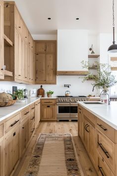 a kitchen with wooden cabinets and an area rug on the floor in front of it