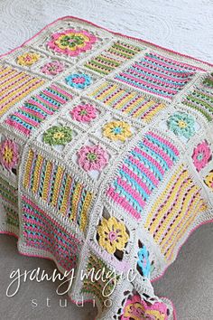 a crocheted blanket with flowers on it