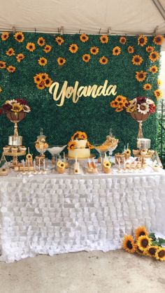 the dessert table is set up with sunflowers