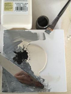 a knife and some paint sitting on top of a table